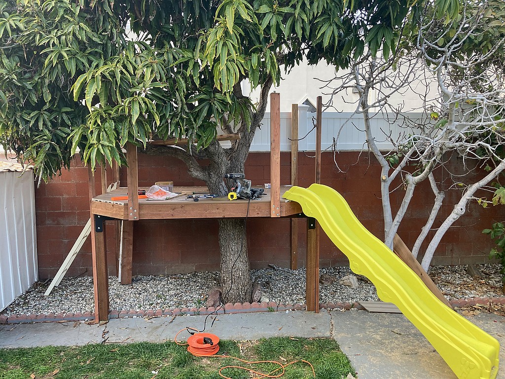 Handrail posts and a slide added to the treehouse